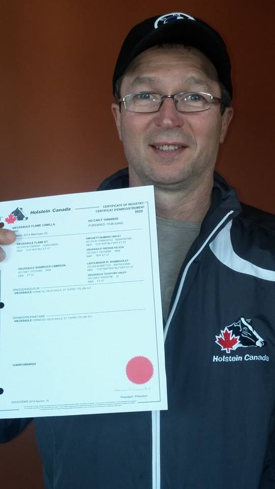 Mario Perreault  with his first official signed registration as Holstein Canada President.