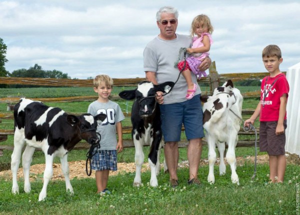 Murray teaching three of his grand children to show calves.