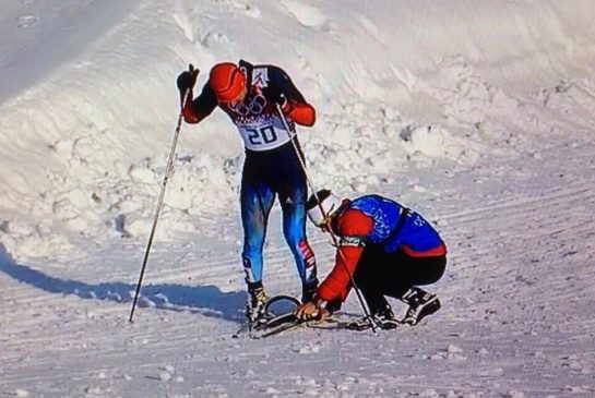 Twitter image of Canadian coach Justin Wadsworth fixing Russian Anton Gafarovski.