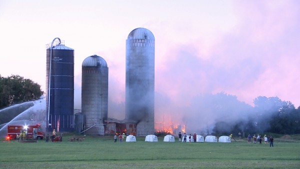 Firefighters work to contain a barn fire in Riceville, Ontario, July 23, 2016